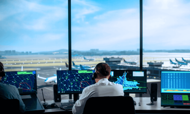 Air traffic controller looking at screens
