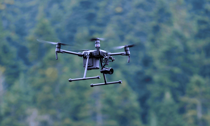 Camera UAV flying in foresty area