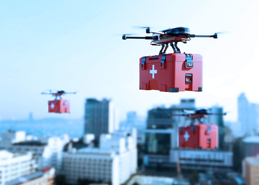 Drones flying in a city carrying medical supplies