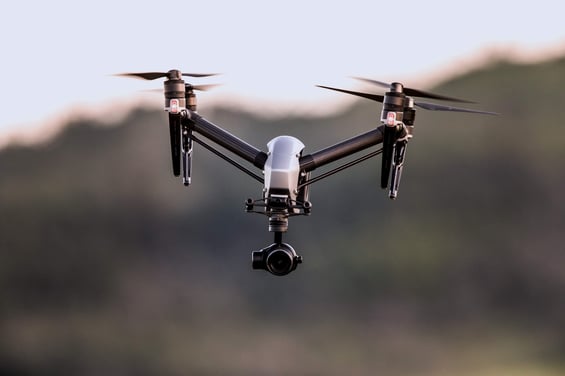 uav with camera flying in countryside